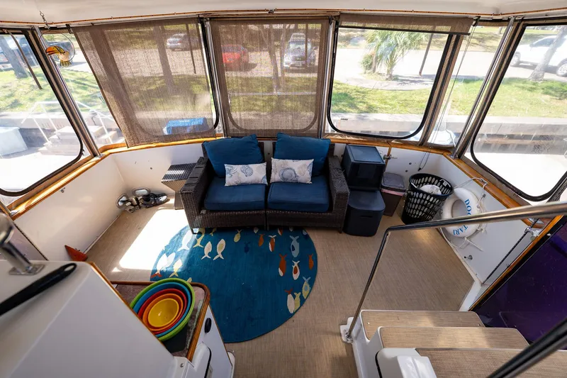 Slide: The Image of 1988 Carver 42 Aft Cabin Motoryacht interior with cozy seating and colorful decor. - 47