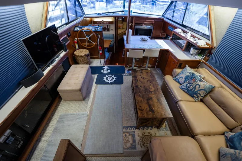 Slide: The Image of Interior of 1988 Carver 42 Aft Cabin Motoryacht with cozy seating and nautical decor. - 49