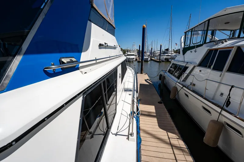Slide: The Image of 1988 Carver 42 Aft Cabin Motoryacht docked at marina under clear blue sky. - 16