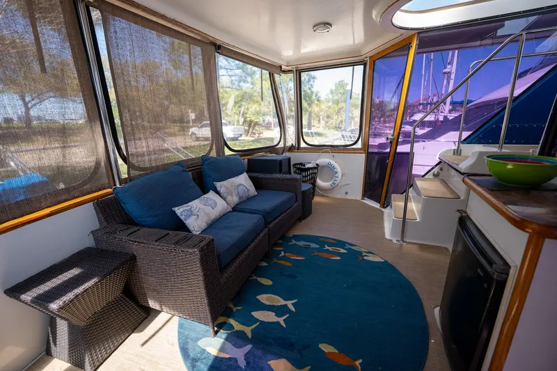 Slide: The Image of 1988 Carver 42 Aft Cabin Motoryacht interior with cozy seating and nautical decor. - 25