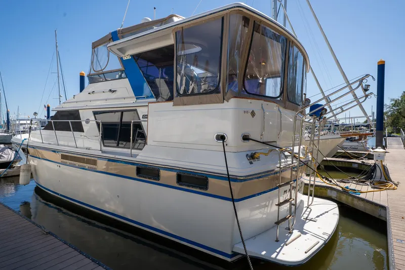 Slide: The Image of 1988 Carver 42 Aft Cabin Motoryacht docked at marina, side view. - 3