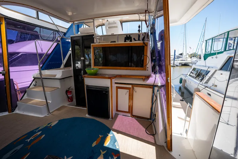 Slide: The Image of 1988 Carver 42 Aft Cabin Motoryacht interior with kitchenette and marina view. - 31