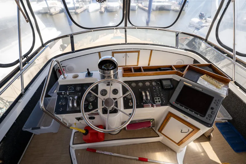 Slide: The Image of Helm of 1988 Carver 42 Aft Cabin Motoryacht with steering wheel and navigation equipment. - 39