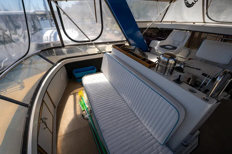 Slide: The Image of 1988 Carver 42 Aft Cabin Motoryacht interior with seating and helm area. - 44