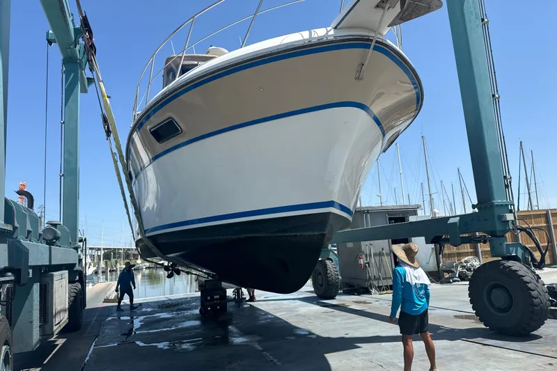Slide: The Image of 1988 Carver 42 Aft Cabin Motor Yacht being lifted at marina. - 117