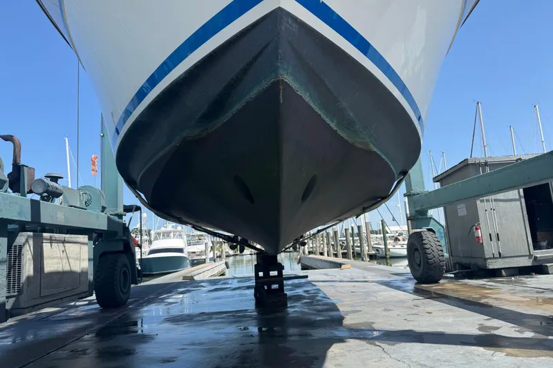 Slide: The Image of 1988 Carver 42 Aft Cabin Motor Yacht on dry dock, marina background. - 112