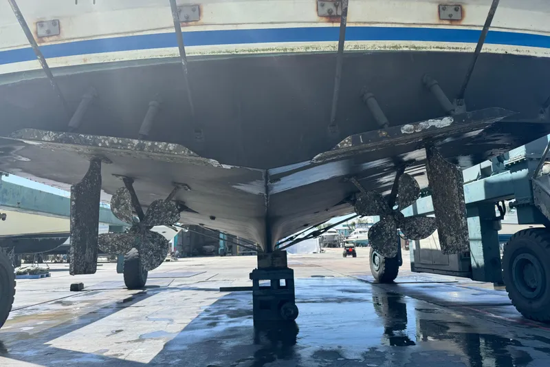 Slide: The Image of 1988 Carver 42 Aft Cabin Motor Yacht propellers and hull in dry dock. - 116