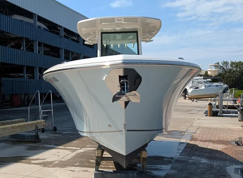 Slide: The Image of 2023 Sailfish 272 CC boat docked at a marina, front view. - 1