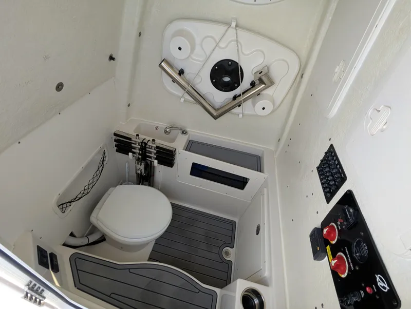 Slide: The Image of 2023 Sailfish 272 CC boat interior with toilet and control panel. - 12