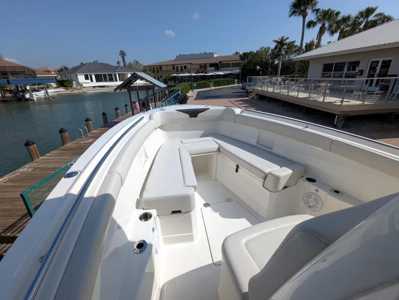 Slide: The Image of 2023 Sailfish 272 CC boat with spacious seating at a dockside location. - 14