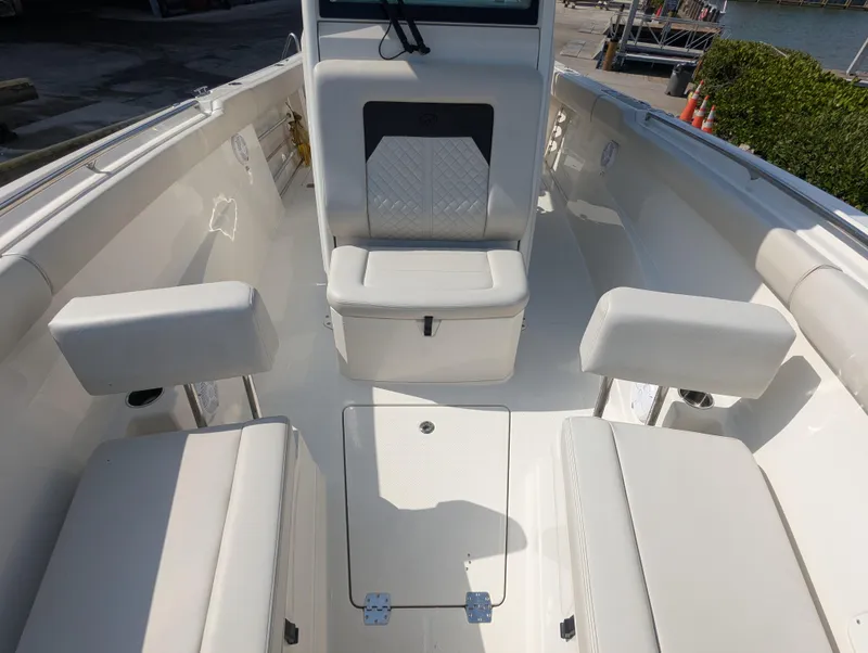 Slide: The Image of 2023 Sailfish 272 CC boat interior with cushioned seating and storage compartments. - 15