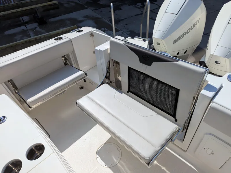 Slide: The Image of 2023 Sailfish 272 CC boat interior with foldable seating and dual Mercury engines. - 27