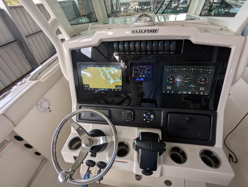 Slide: The Image of 2023 Sailfish 272 CC boat dashboard with advanced navigation and control systems. - 5