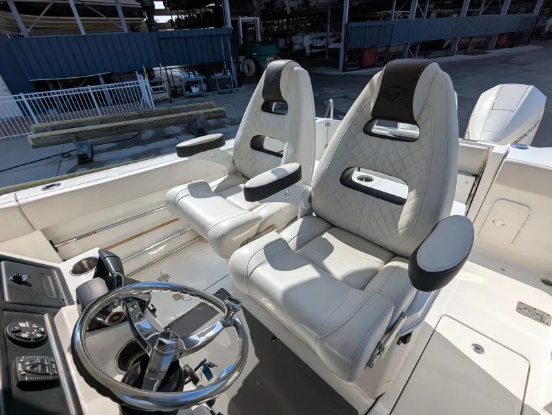 Slide: The Image of 2023 Sailfish 272 CC boat interior with luxurious seating and modern steering wheel. - 8
