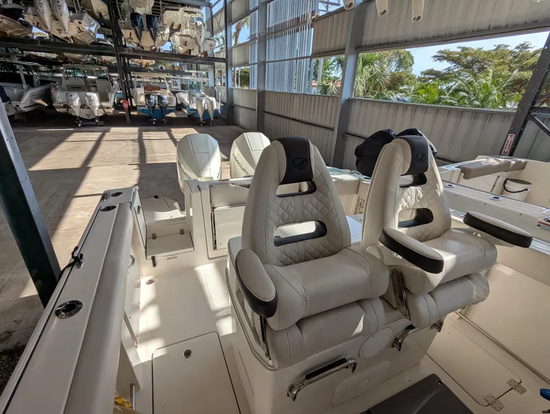 Slide: The Image of 2023 Sailfish 272 CC boat interior with luxurious seating in a storage facility. - 9