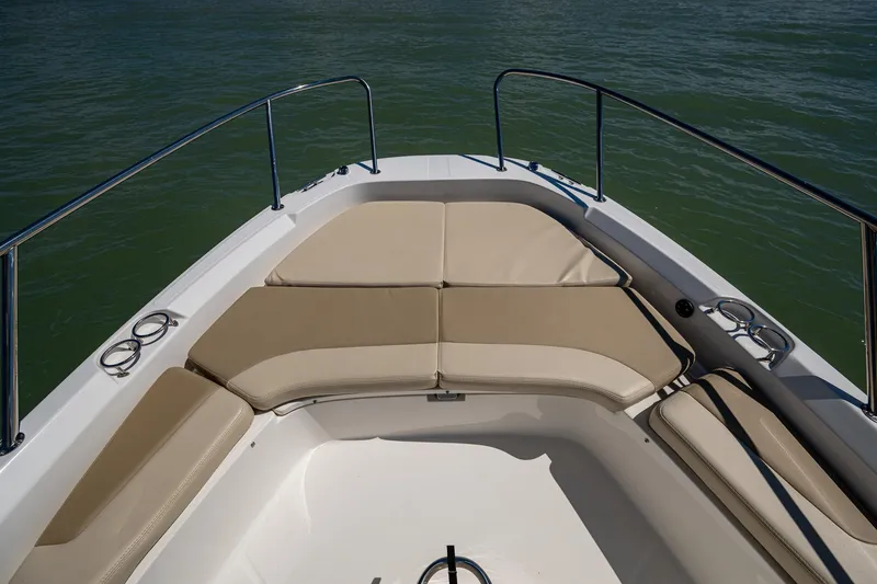 Slide: The Image of 2020 Boston Whaler 210 Dauntless boat bow with cushioned seating and stainless steel railings. - 10
