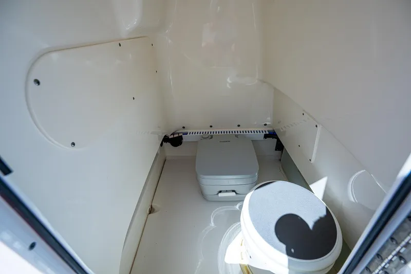 Slide: The Image of 2020 Boston Whaler 210 Dauntless interior with portable toilet, white finish. - 18