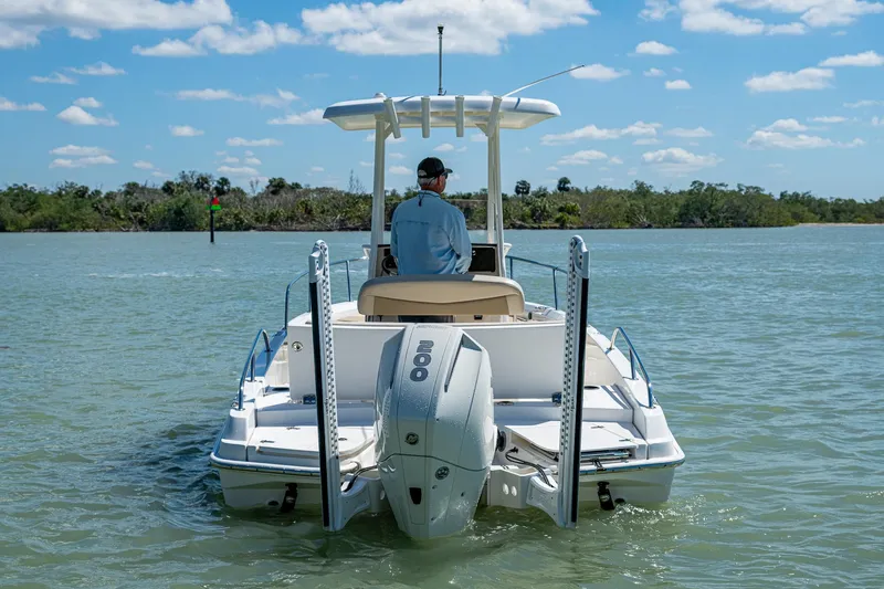 Slide: The Image of 2020 Boston Whaler 210 Dauntless boat on calm water, rear view. - 2