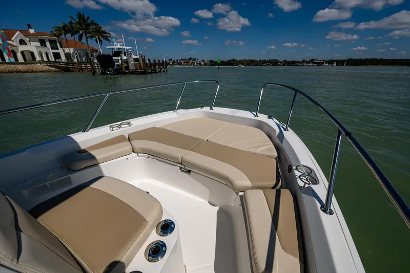 Slide: The Image of Boston Whaler 210 Dauntless 2020 boat interior with cushioned seating on calm water. - 8