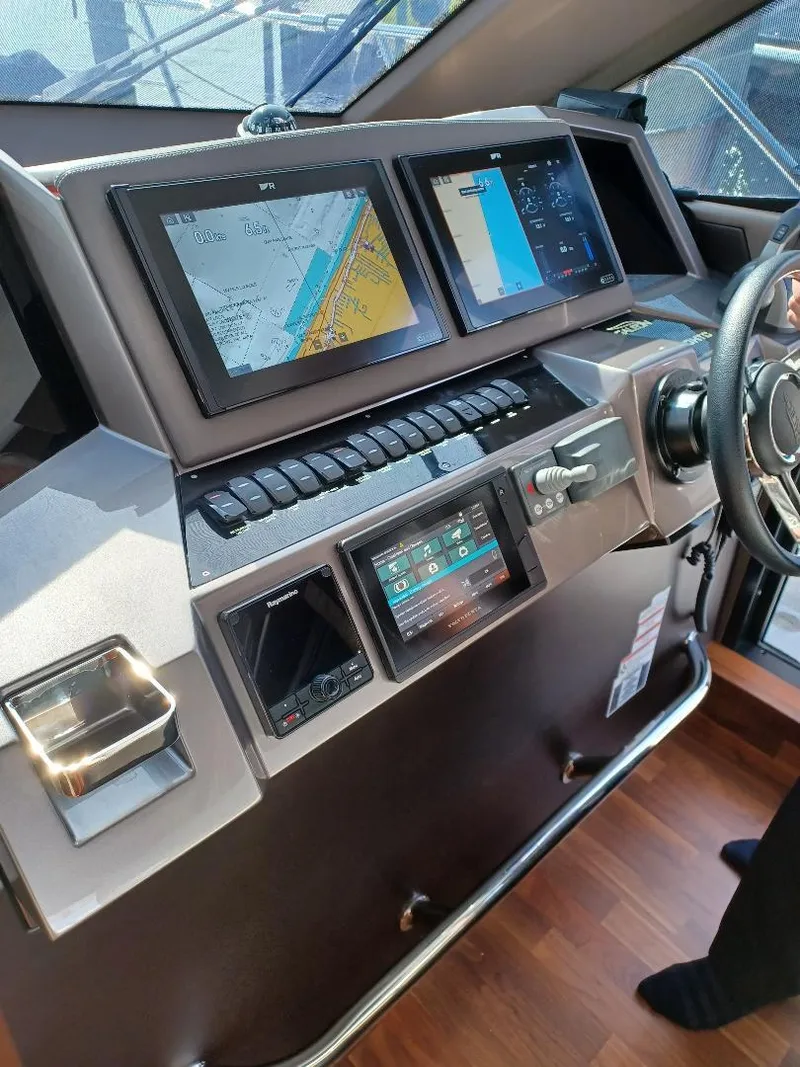 Slide: The Image of 2022 Galeon 410 HTC yacht helm with navigation screens and controls. - 17