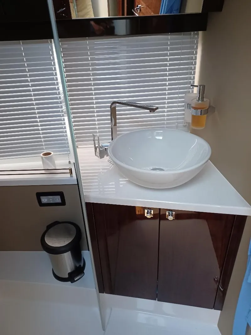 Slide: The Image of Modern bathroom sink in 2022 Galeon 410 HTC yacht with sleek design and fixtures. - 23