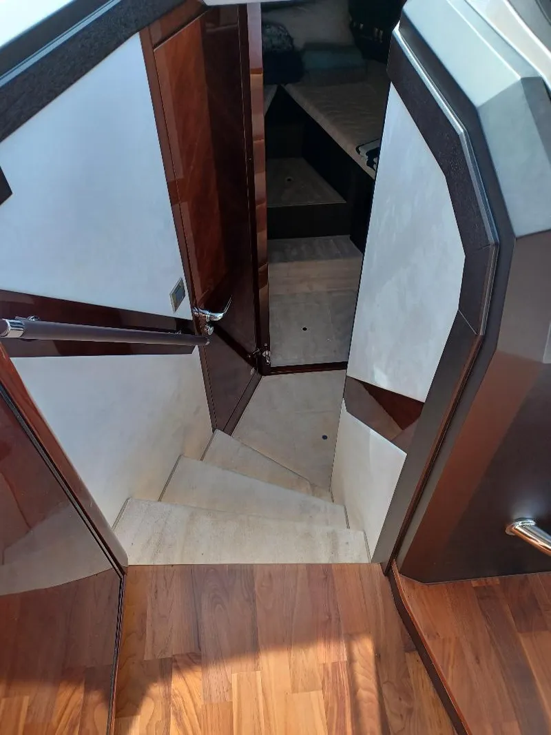 Slide: The Image of Interior staircase of 2022 Galeon 410 HTC yacht, featuring elegant wood finishes. - 27