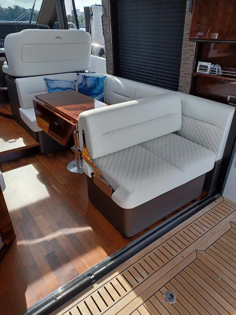 Slide: The Image of Interior of 2022 Galeon 410 HTC yacht with white seating and wooden flooring. - 31