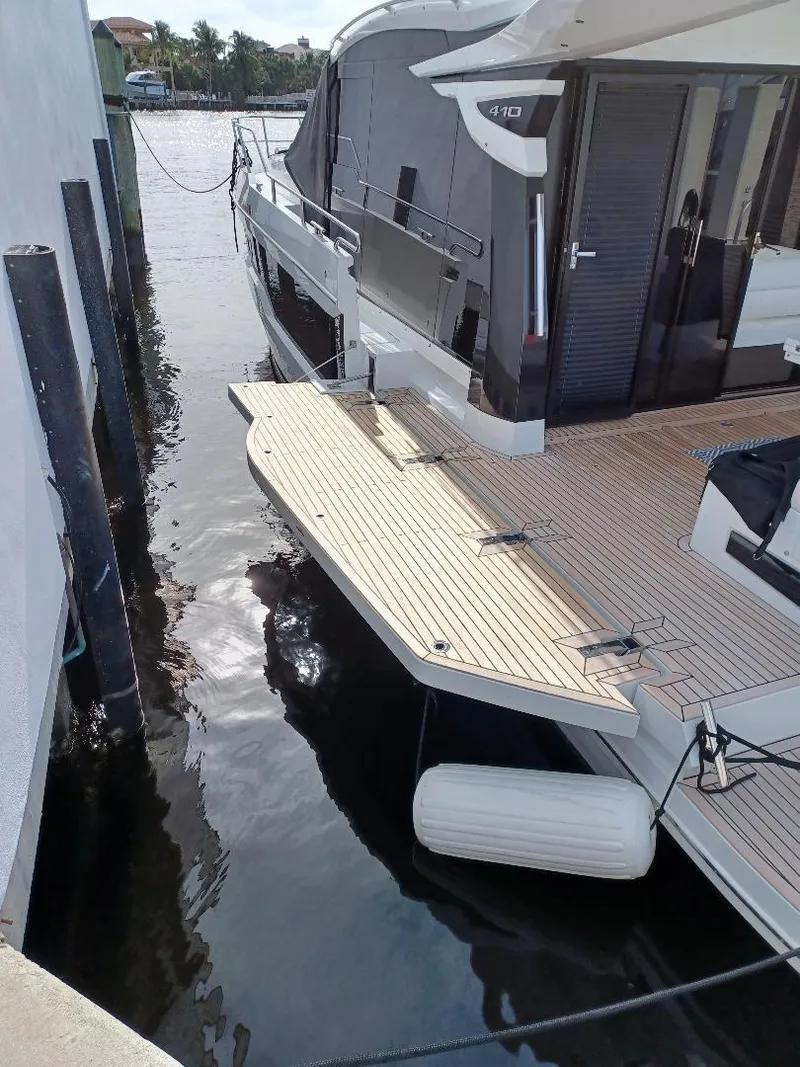 Slide: The Image of 2022 Galeon 410 HTC yacht docked, featuring sleek design and spacious deck. - 36