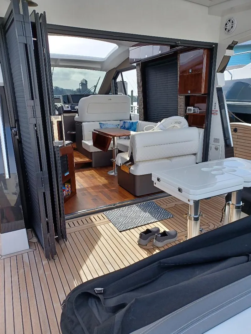 Slide: The Image of 2022 Galeon 410 HTC yacht interior with modern seating and wooden flooring. - 45