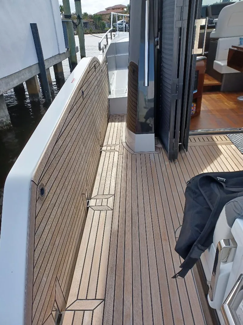 Slide: The Image of 2022 Galeon 410 HTC yacht deck with wood finish and seating area. - 46