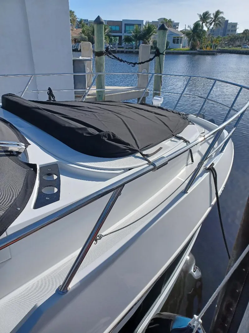 Slide: The Image of 2022 Galeon 410 HTC yacht docked by waterfront with covered deck. - 48