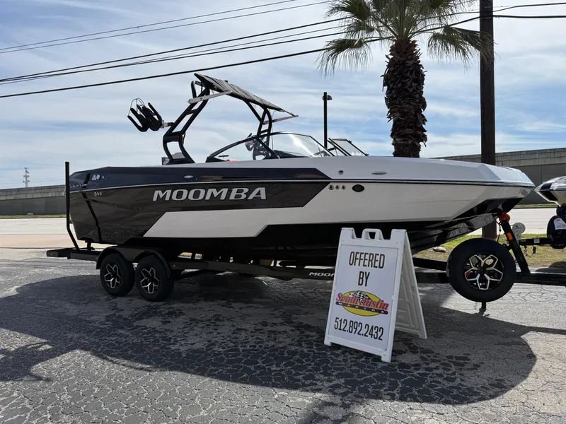 The Image of 2025 Moomba Tykon boat displayed outdoors with a sales sign. - 0