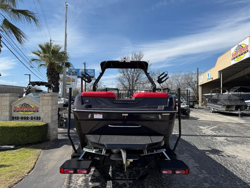 Slide: The Image of 2025 Moomba Tykon boat, rear view, parked outdoors at a dealership. - 14