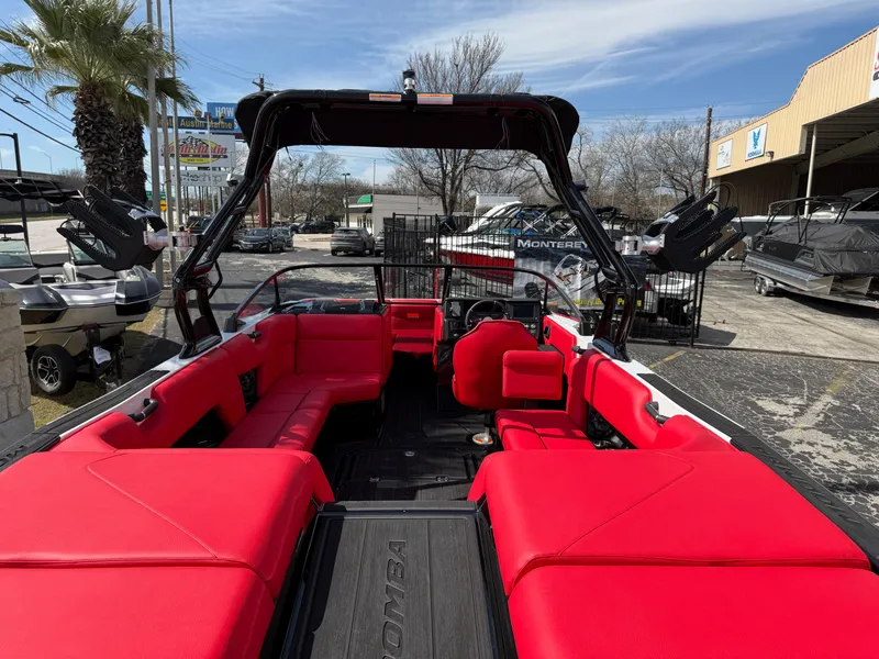 Slide: The Image of 2025 Moomba Tykon boat with vibrant red seating and sleek design. - 25