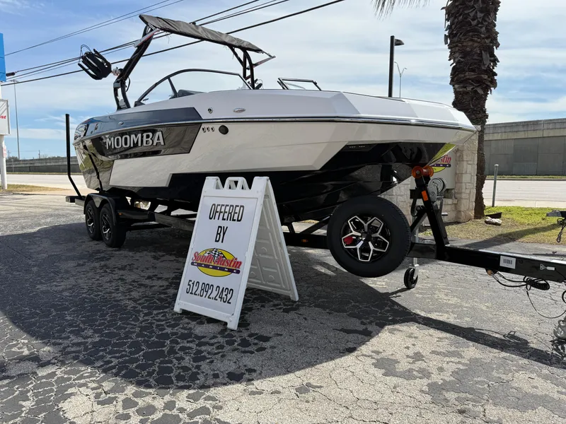 Slide: The Image of 2025 Moomba Tykon boat on trailer, displayed outdoors with contact sign. - 3