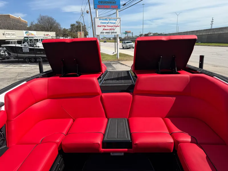 Slide: The Image of 2025 Moomba Tykon boat with vibrant red seating and open storage compartments. - 33