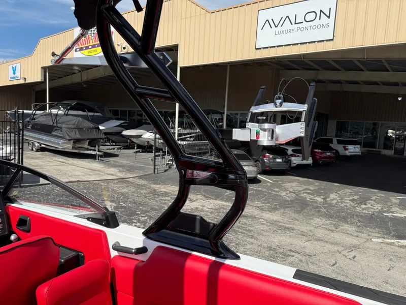 Slide: The Image of 2025 Moomba Tykon boat at Avalon Luxury Pontoons dealership, featuring red interior and black tower. - 38