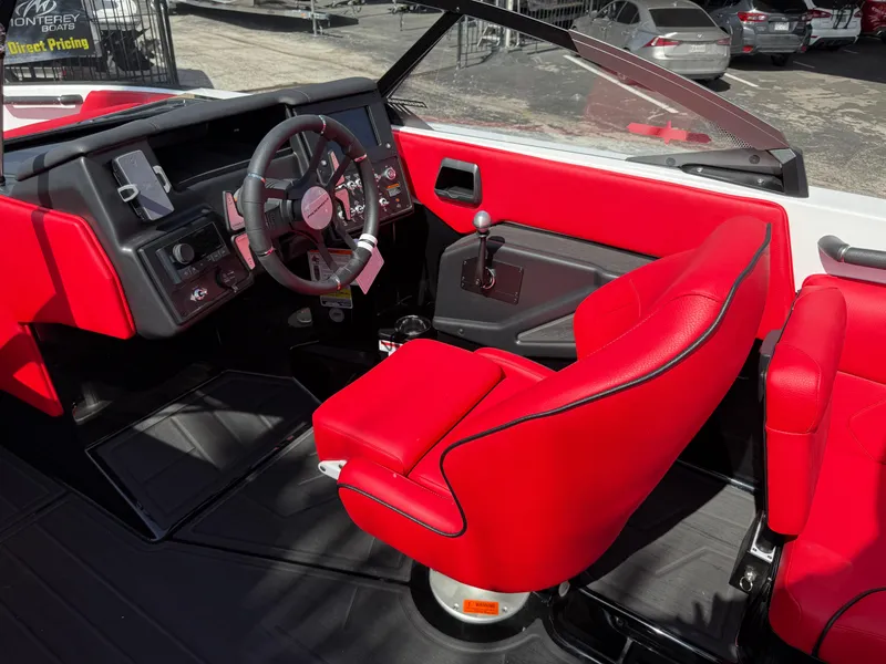 Slide: The Image of 2025 Moomba Tykon boat interior with red seats and modern dashboard. - 44