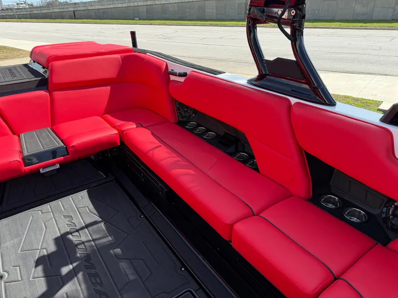 Slide: The Image of 2025 Moomba Tykon boat interior with vibrant red seating and sleek design. - 46