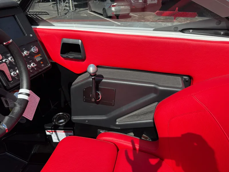 Slide: The Image of Interior of 2025 Moomba Tykon boat with red upholstery and control panel. - 48