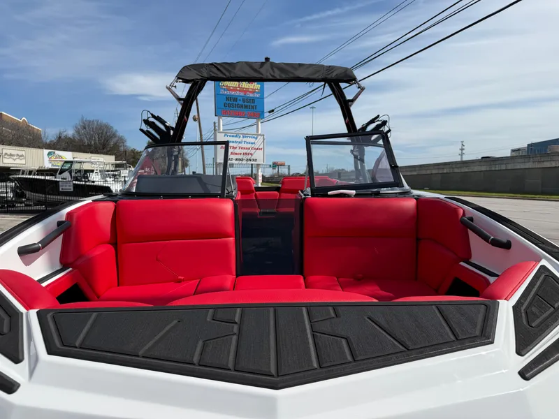 Slide: The Image of 2025 Moomba Tykon boat with vibrant red seating and sleek design. - 6