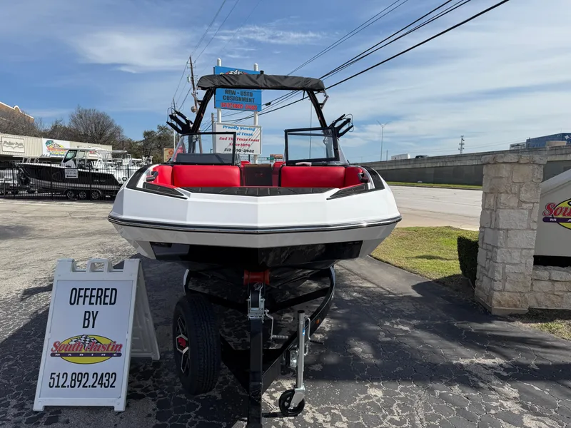 Slide: The Image of 2025 Moomba Tykon boat on trailer, displayed outdoors with signage. - 7