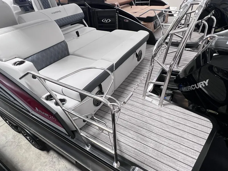 Slide: The Image of 2024 Harris Sunliner 250 boat interior with seating and stainless steel railings. - 11