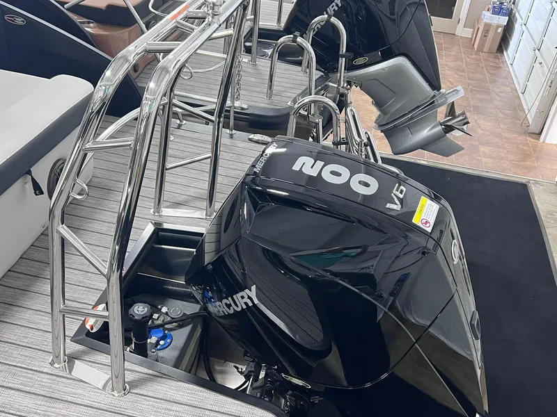 Slide: The Image of 2024 Harris Sunliner 250 boat with Mercury V6 engine and sleek design. - 12