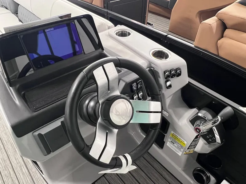 Slide: The Image of 2024 Harris Sunliner 250 boat dashboard with steering wheel and control panel. - 14