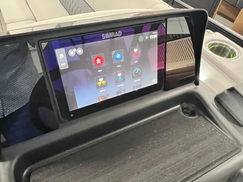 Slide: The Image of Simrad touchscreen display on 2024 Harris Sunliner 250 boat dashboard. - 15