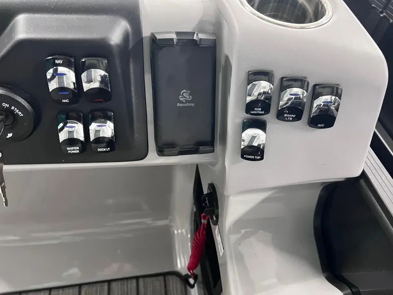 Slide: The Image of Control panel of 2024 Harris Sunliner 250 boat with switches and key ignition. - 16