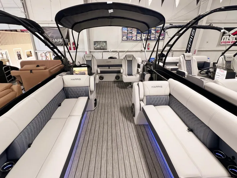 Slide: The Image of 2024 Harris Sunliner 250 pontoon boat interior with luxurious seating and canopy. - 19