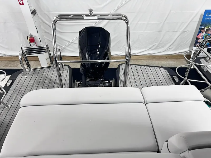 Slide: The Image of 2024 Harris Sunliner 250 boat interior with sleek seating and modern engine design. - 24