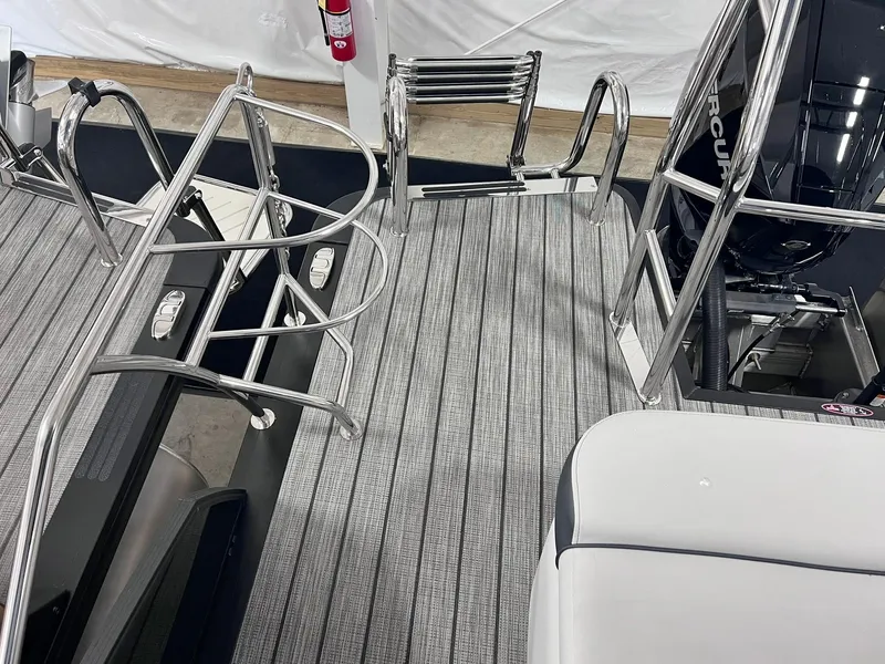 Slide: The Image of 2024 Harris Sunliner 250 boat deck with sleek metal railings and modern design. - 25